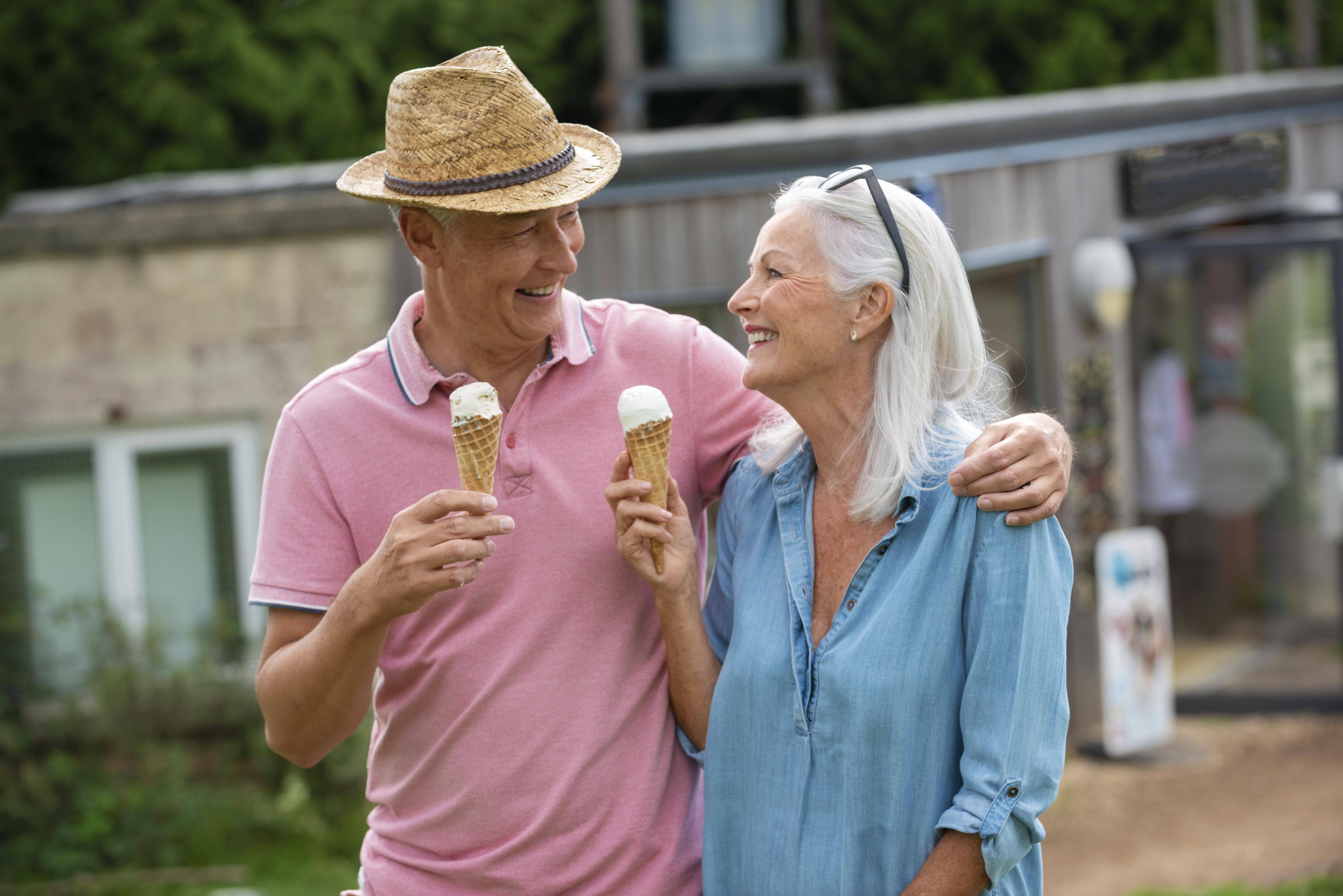 adorable-senior-couple-enjoying-some-ice-cream-together-outdoors